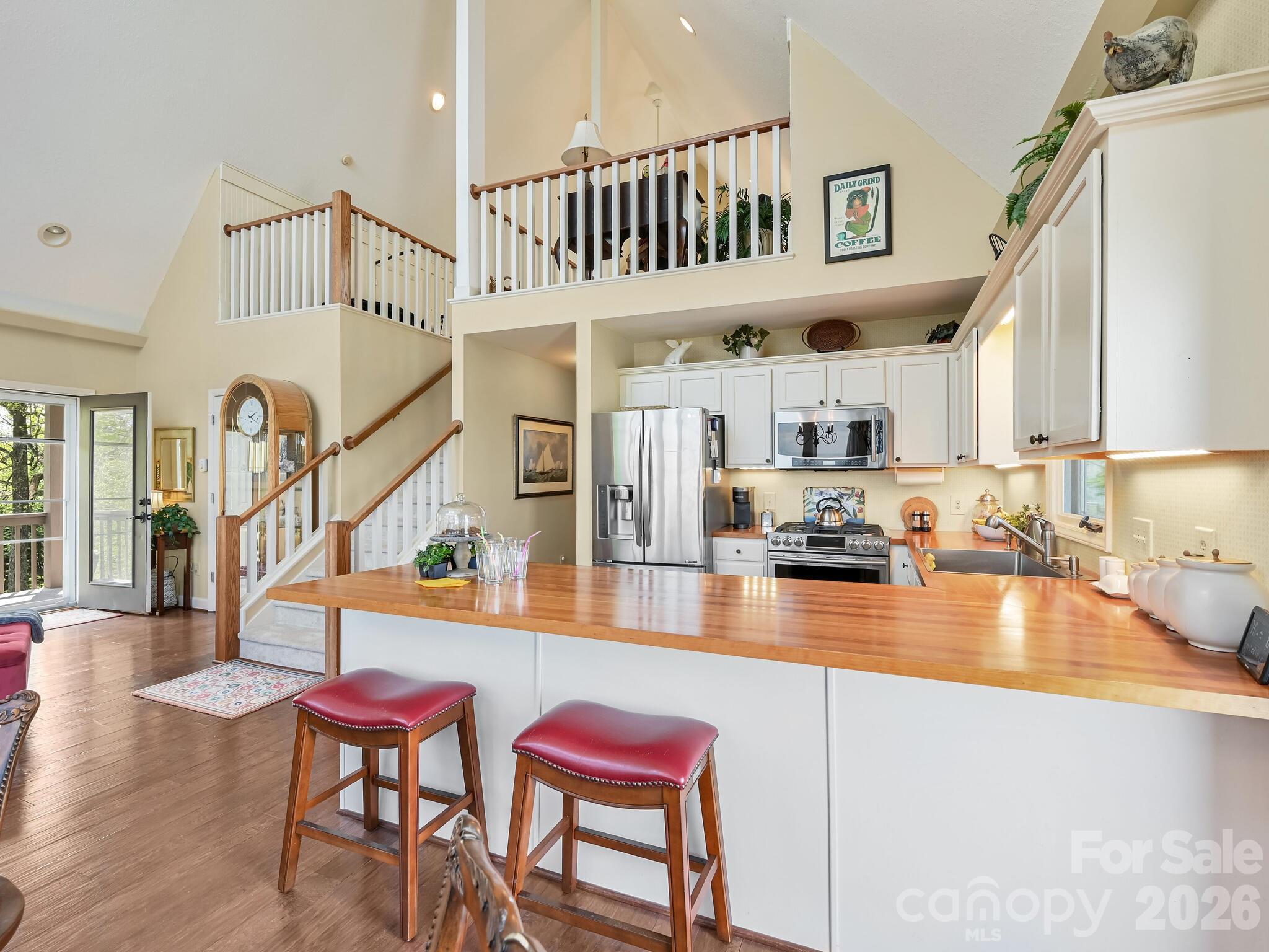107 Fawns Rest Black Mountain, NC 28711 - Photo 16 of 47 a kitchen with stainless steel appliances kitchen island granite countertop a table chairs in it and wooden floor