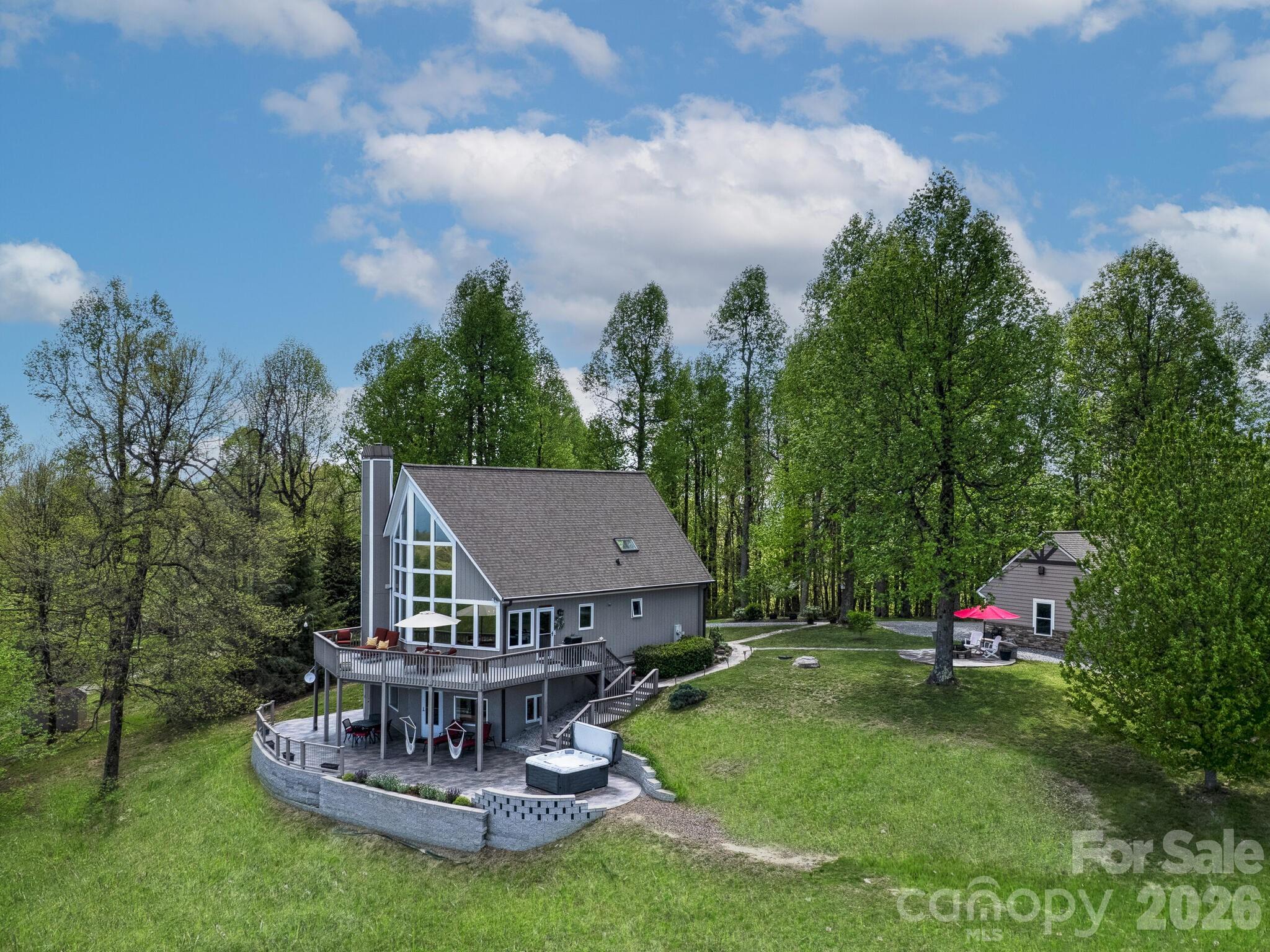 107 Fawns Rest Black Mountain, NC 28711 - Photo 2 of 47 an aerial view of a house with table and chairs potted plants and large tree