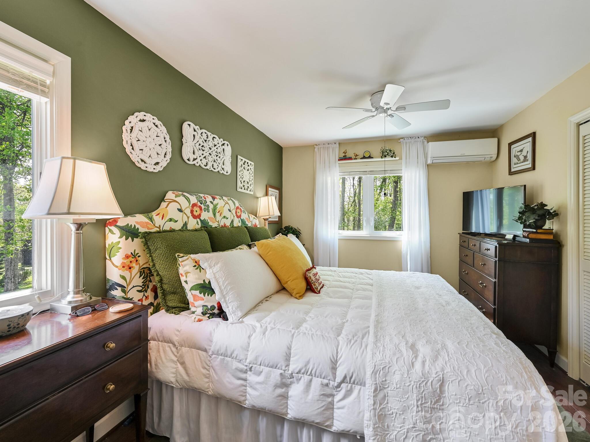 107 Fawns Rest Black Mountain, NC 28711 - Photo 22 of 47 a bedroom with a bed and a lamp on dresser next to a window