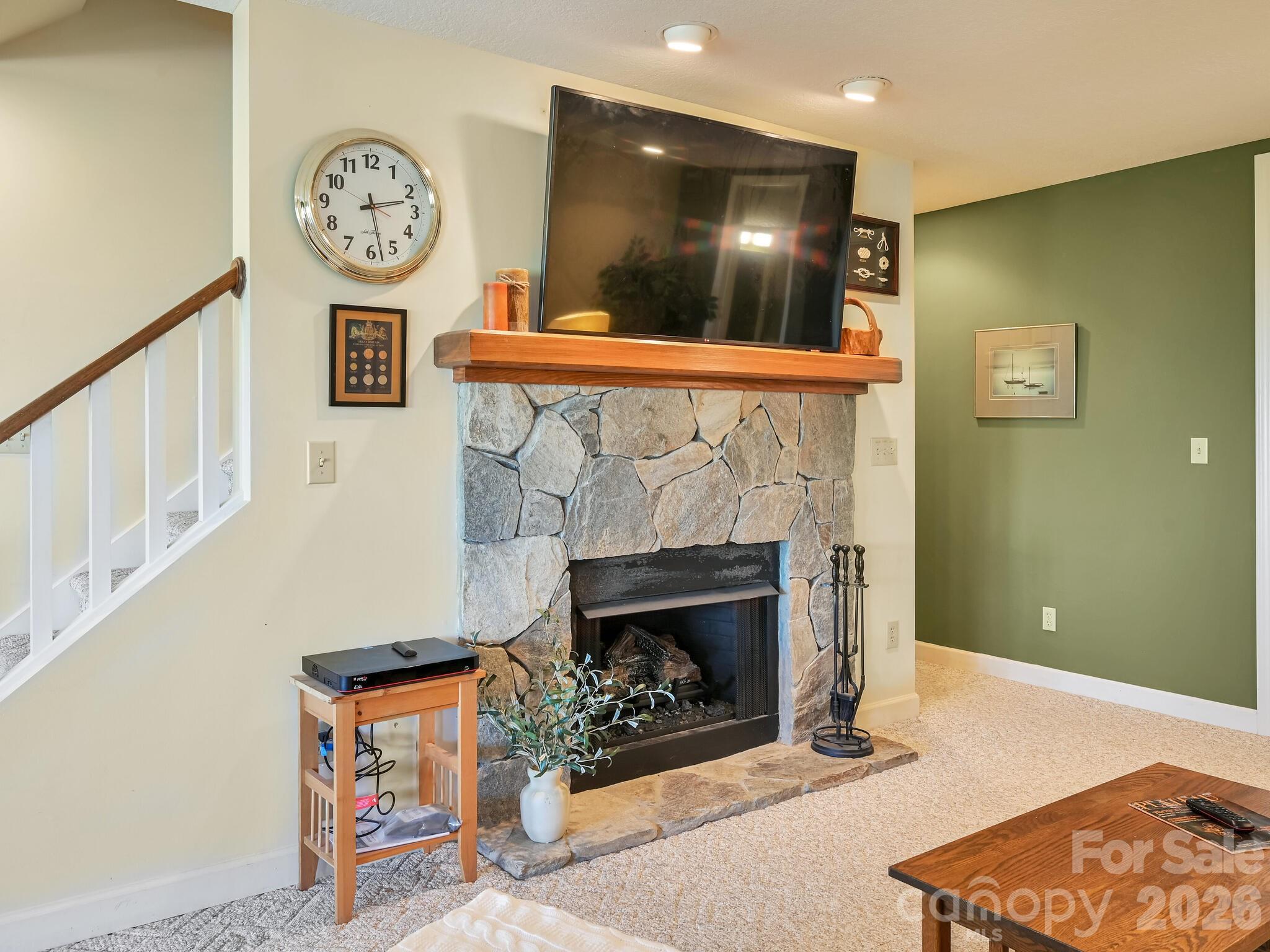 107 Fawns Rest Black Mountain, NC 28711 - Photo 28 of 47 a living room with furniture a flat screen tv and a fireplace
