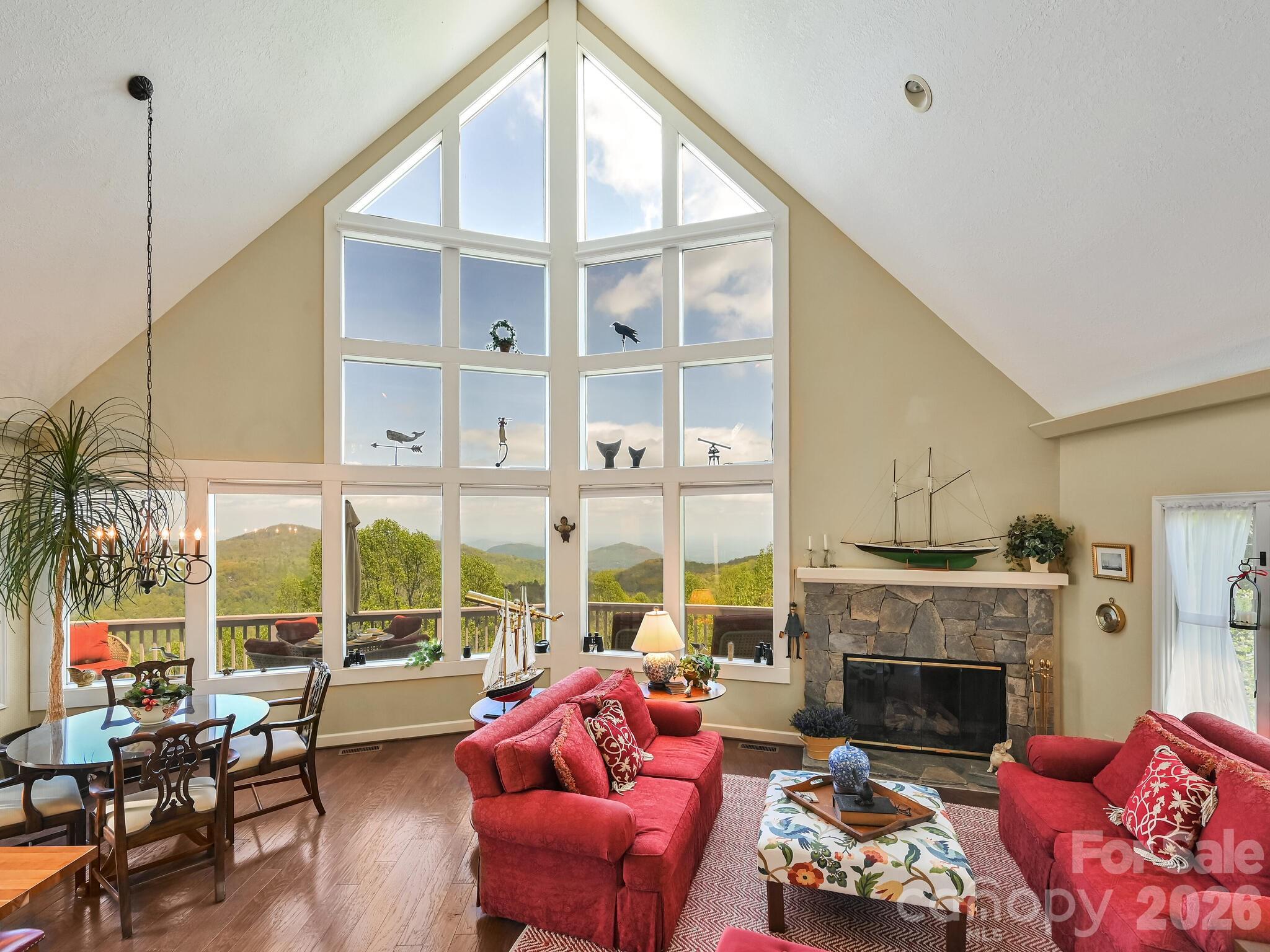 107 Fawns Rest Black Mountain, NC 28711 - Photo 10 of 47 a living room with furniture a fireplace and floor to ceiling windows