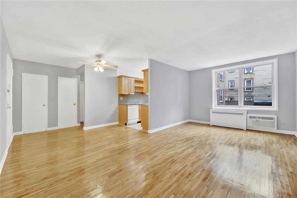 9411 Shore Road, Unit 1I Brooklyn, NY 11209 - Photo 3 of 13 a view of an empty room with a window and wooden floor