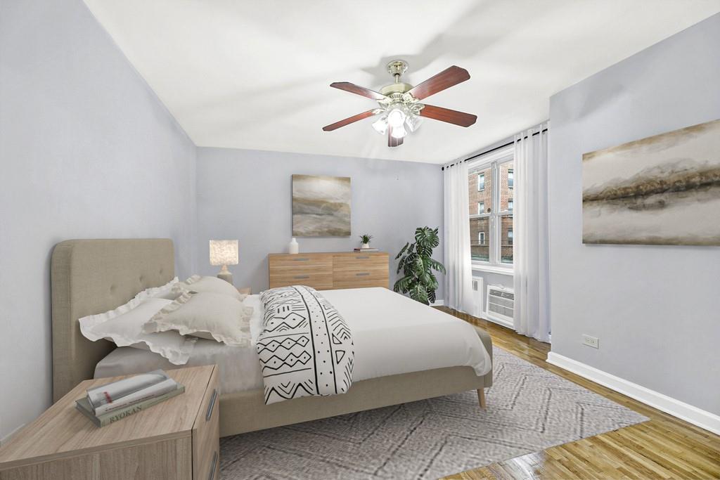 9411 Shore Road, Unit 1I Brooklyn, NY 11209 - Photo 7 of 13 a bedroom with a large bed and a chandelier