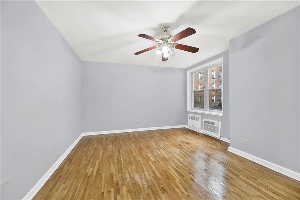 9411 Shore Road, Unit 1I Brooklyn, NY 11209 - Photo 8 of 13 wooden floor in an empty room with a window