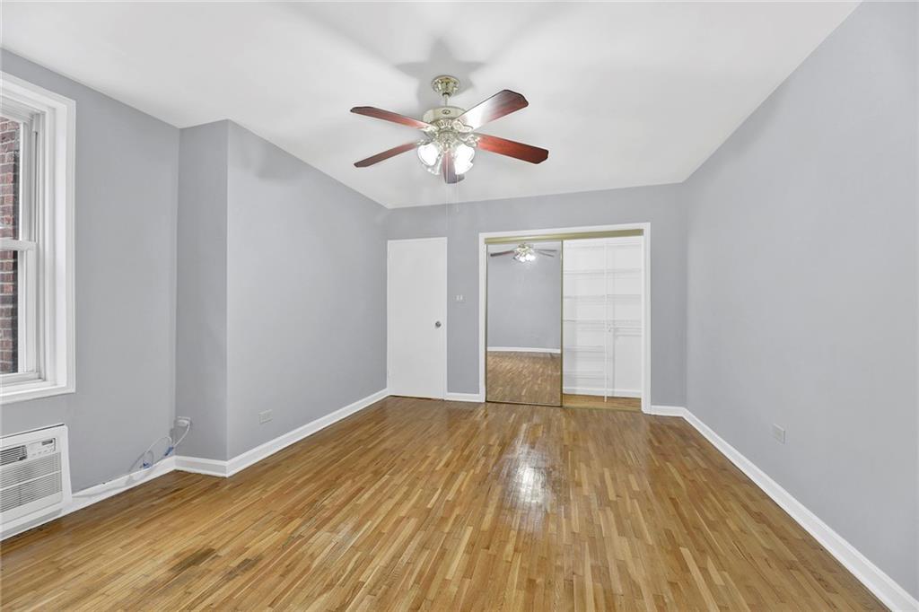 9411 Shore Road, Unit 1I Brooklyn, NY 11209 - Photo 9 of 13 a view of an empty room with window and wooden floor