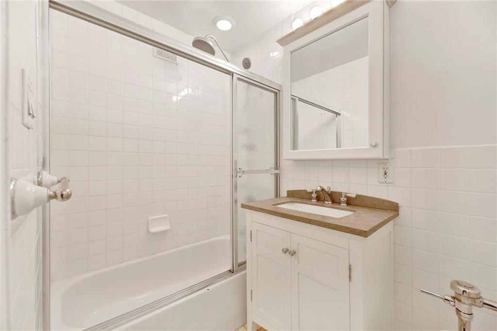 9411 Shore Road, Unit 1I Brooklyn, NY 11209 - Photo 10 of 13 a bathroom with a sink and a shower