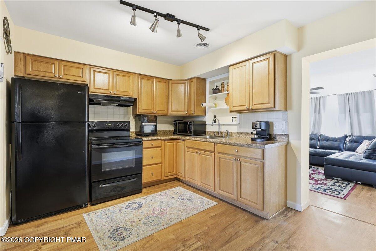 208 Shine Hill Road Henryville, PA 18332 - Photo 11 of 38 a kitchen with a refrigerator and a stove top oven
