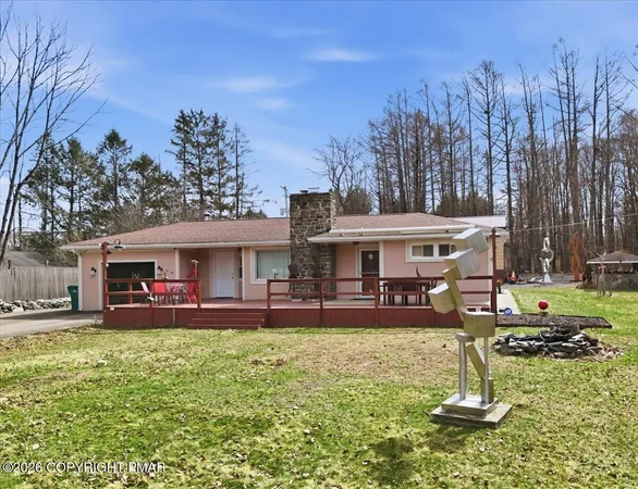 a view of a house with a yard patio and fire pit