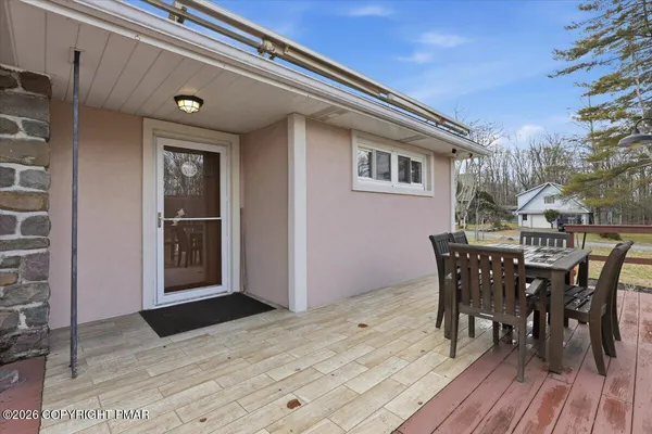 a view of a house with a dining table and chairs