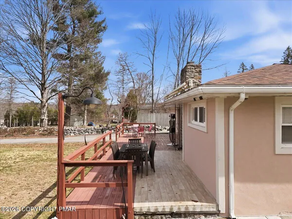 a backyard of a house with table and chairs