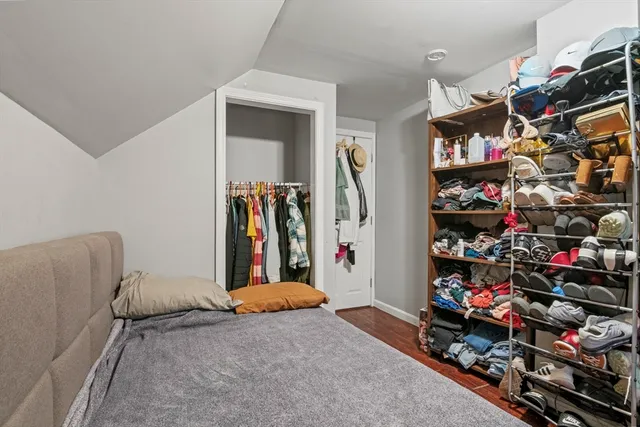 a bedroom with furniture and a wooden floor