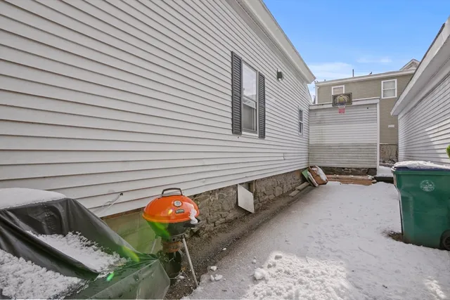a view of a small house and a yard