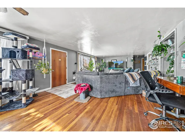 a open kitchen with cabinets a stove a sink and a large window