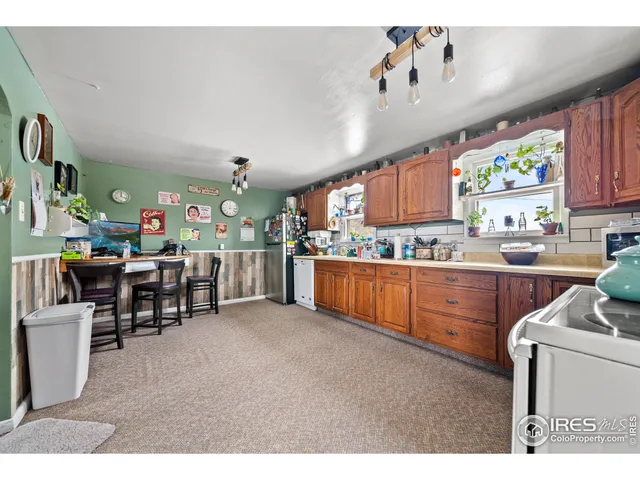 a kitchen with granite countertop white cabinets and white appliances