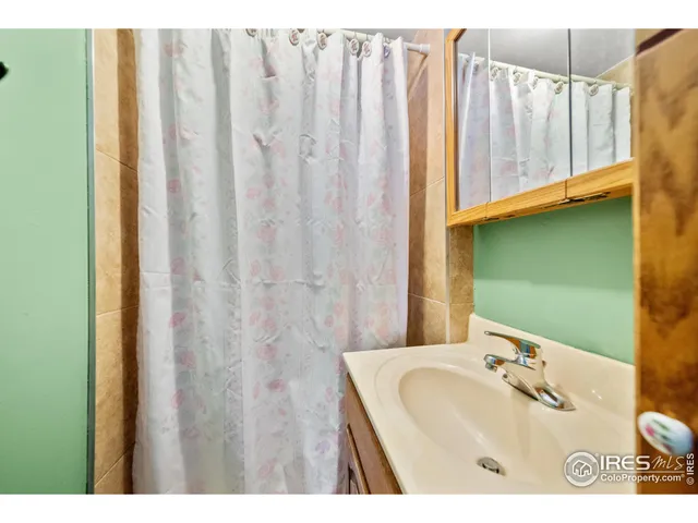 a bedroom with furniture and a flat screen tv