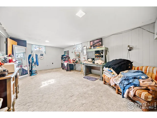 a living room with furniture and a dining table