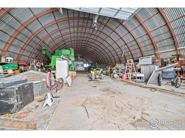 a backyard of a house with large trees and plants