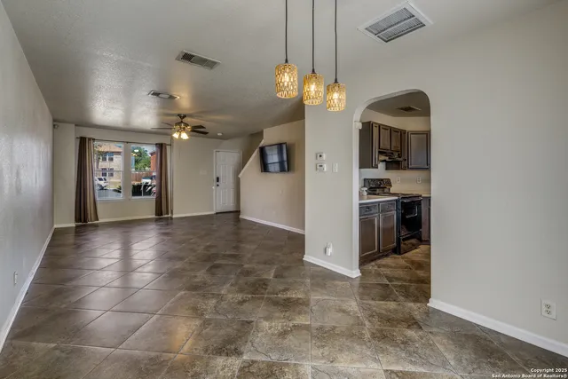 a view of a big room with windows and chandelier