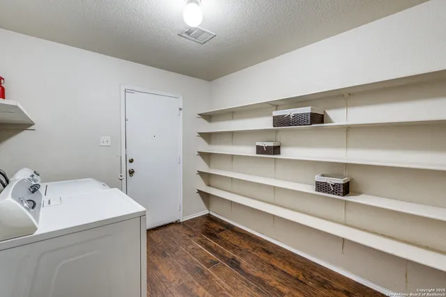 a view of storage and utility room with washer and dryer
