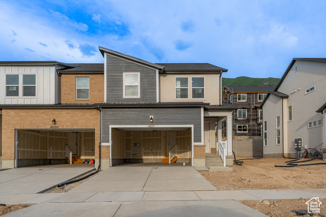 4617 Olive Avenue, Unit 335 Mapleton, UT 84664 - Photo 1 of 1 View of front of home with a garage, driveway, brick siding, and board and batten siding
