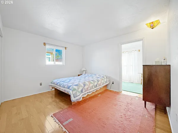 a bedroom with a bed and painting on the wall