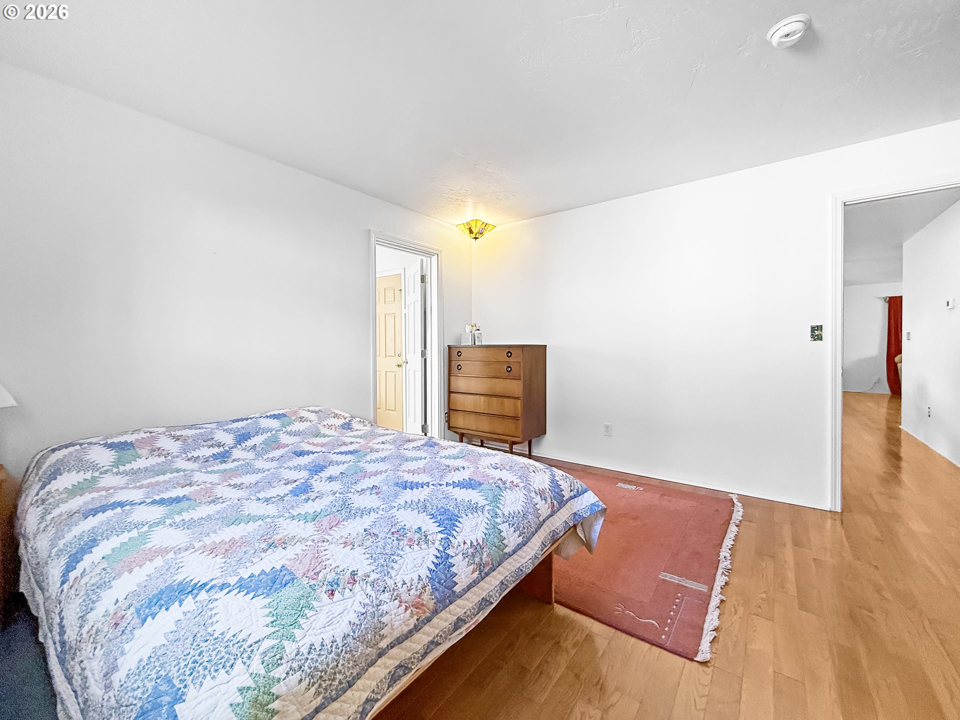 17197 Passley Road Brookings, OR 97415 - Photo 16 of 46 a bedroom with a bed and wooden floor