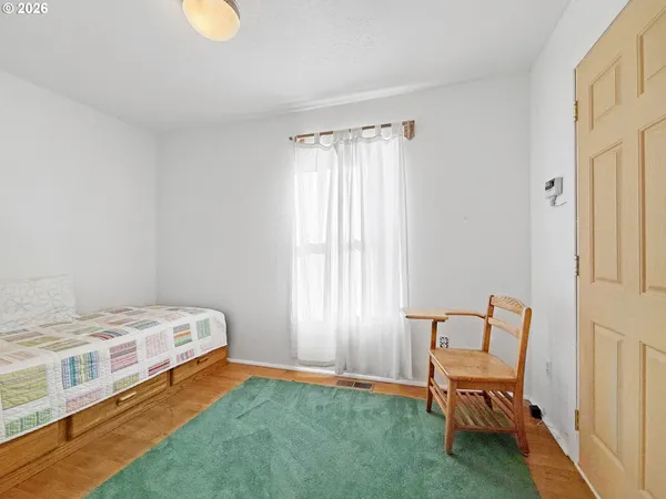 a bedroom with a bed and chair