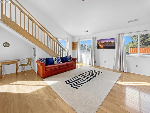 a bedroom with furniture and a rug