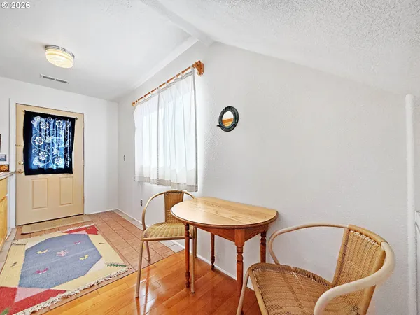 a view of a bedroom with furniture and window