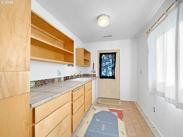 a kitchen with granite countertop a sink and a stove top oven