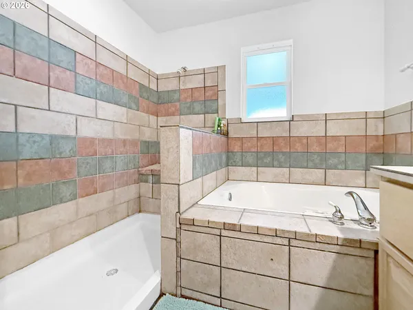 a bathroom with a bathtub and a shower