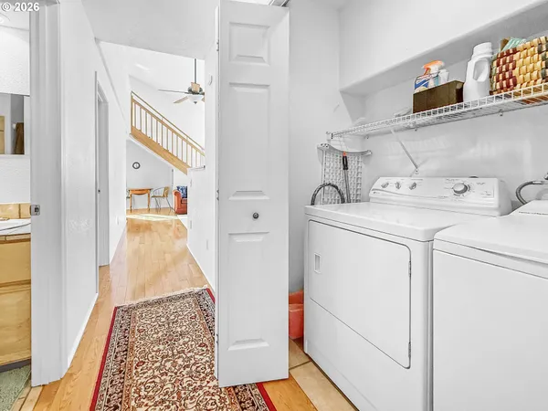 a view of a hallway with washer and dryer