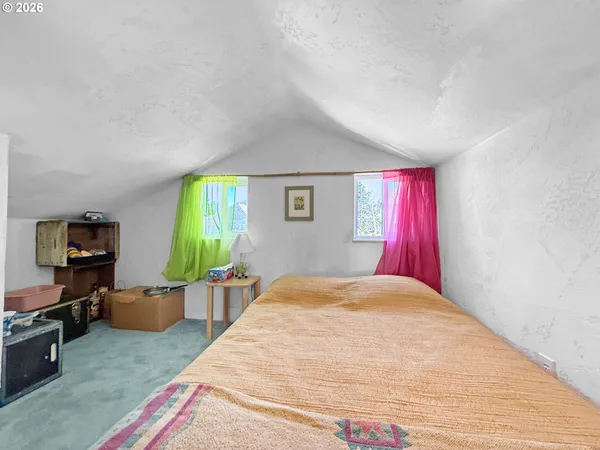 a bedroom with a bed and a couch