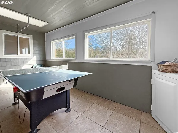 a room with pool table and windows