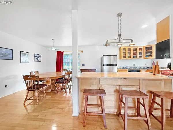 a kitchen with stainless steel appliances kitchen island granite countertop a table and chairs
