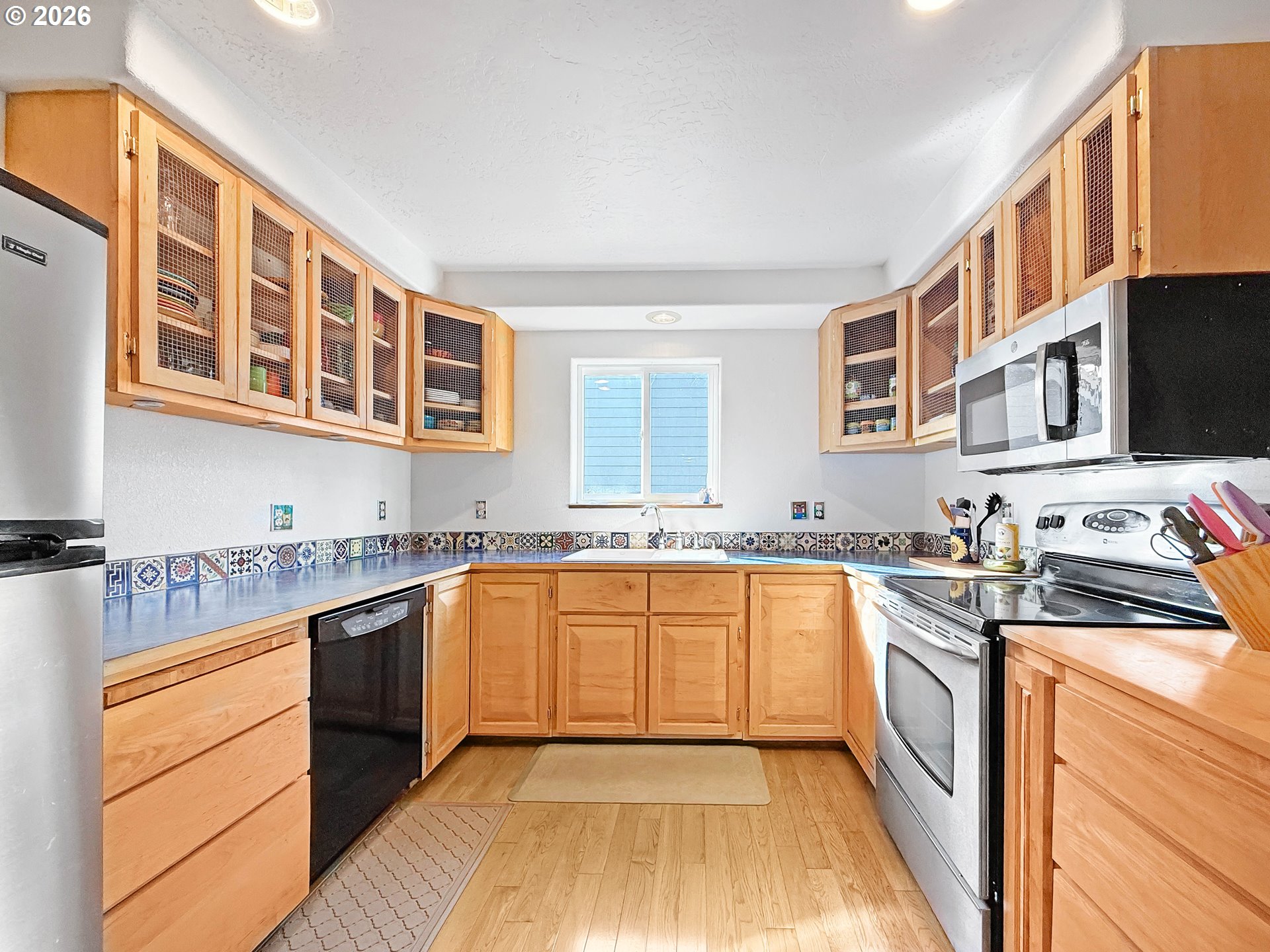 17197 Passley Road Brookings, OR 97415 - Photo 9 of 46 a kitchen with stainless steel appliances granite countertop a stove and a sink