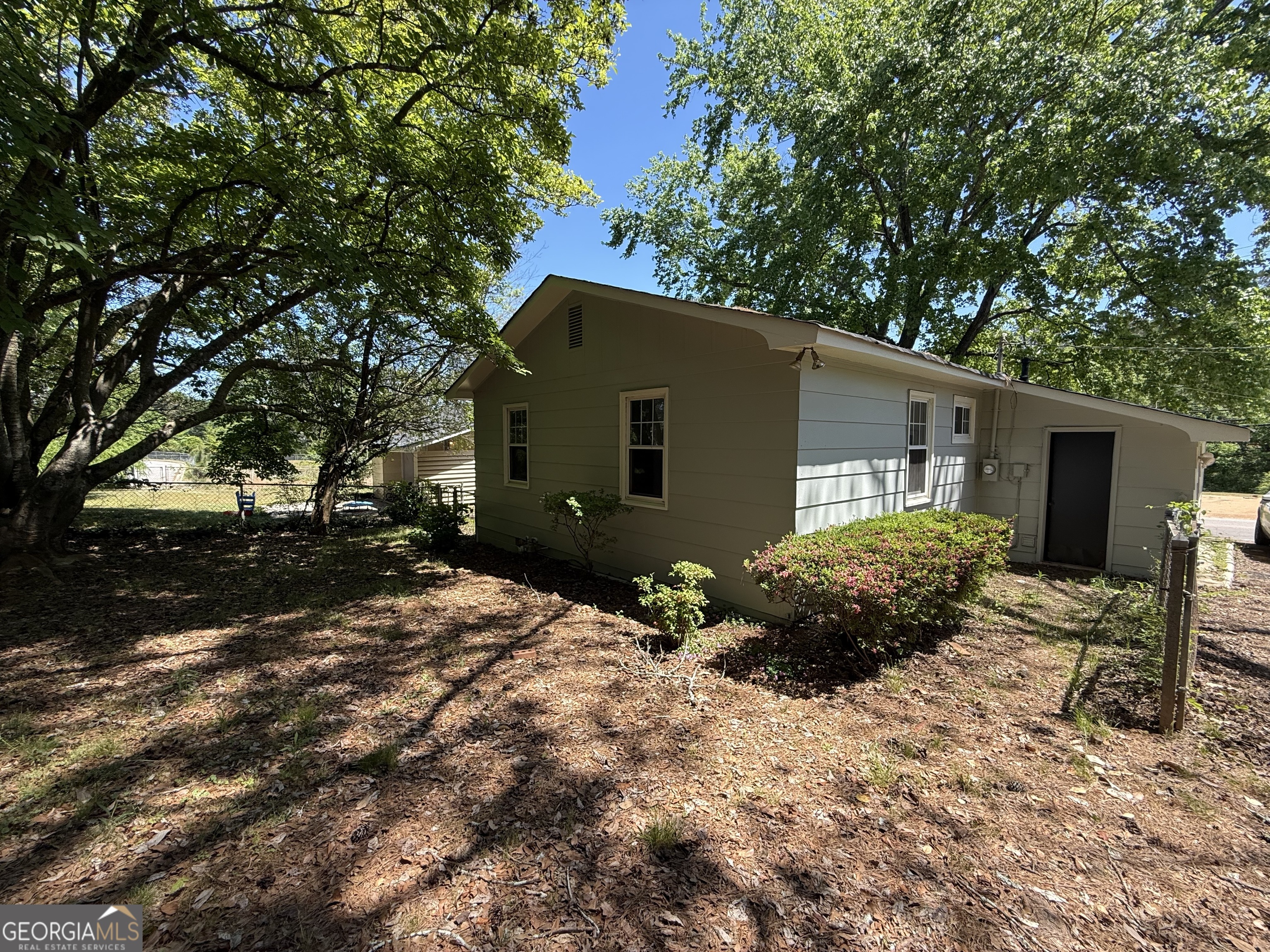 179 Youngs Mill Road LaGrange, GA 30241 - Photo 29 of 30 a backyard of a house with plants and tree