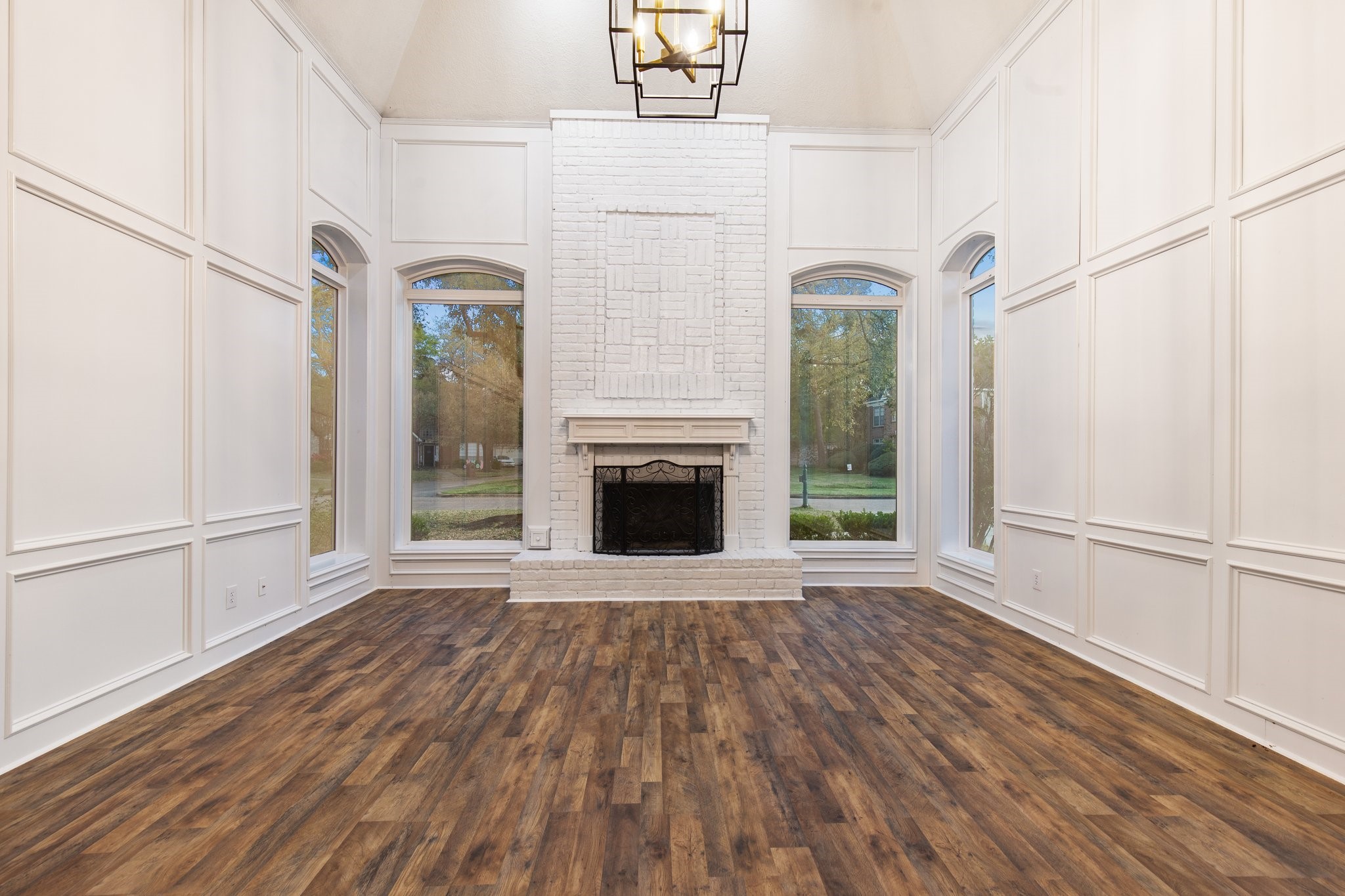 17902 Fernbluff Drive Spring, TX 77379 - Photo 11 of 38 a view of a livingroom with wooden floor a fireplace and windows