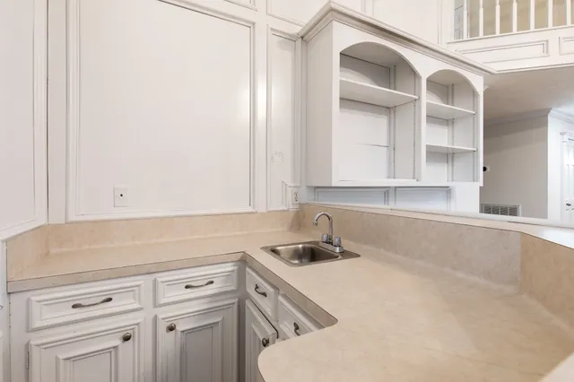a kitchen with a sink and cabinets