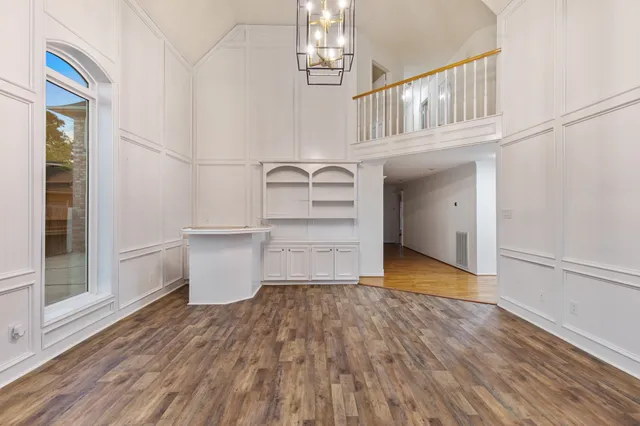 a view of a room with wooden floor and window