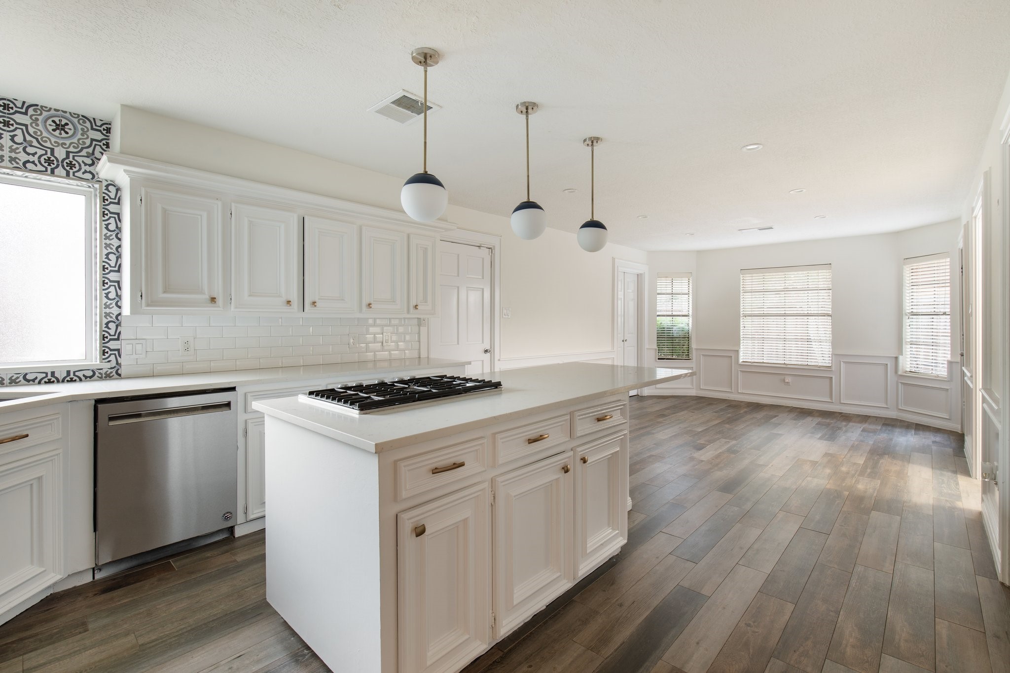 17902 Fernbluff Drive Spring, TX 77379 - Photo 16 of 38 a kitchen with granite countertop a stove and a wooden floors