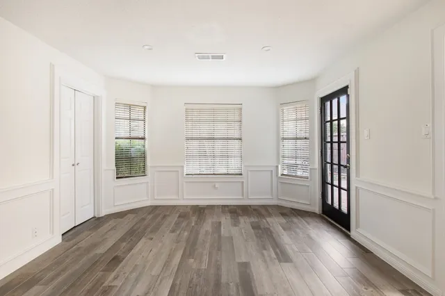wooden floor in an empty room with a window
