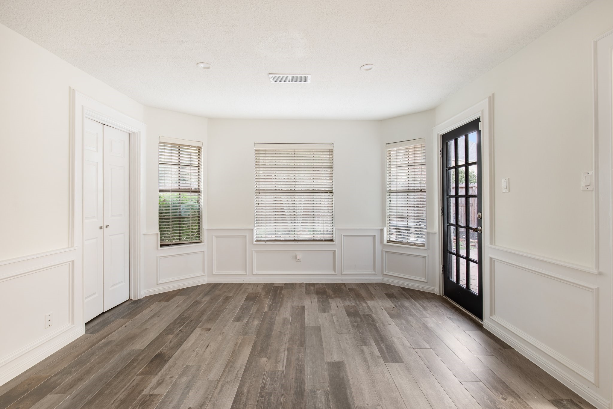 17902 Fernbluff Drive Spring, TX 77379 - Photo 17 of 38 wooden floor in an empty room with a window
