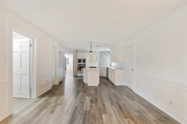 a view of a kitchen with wooden floor