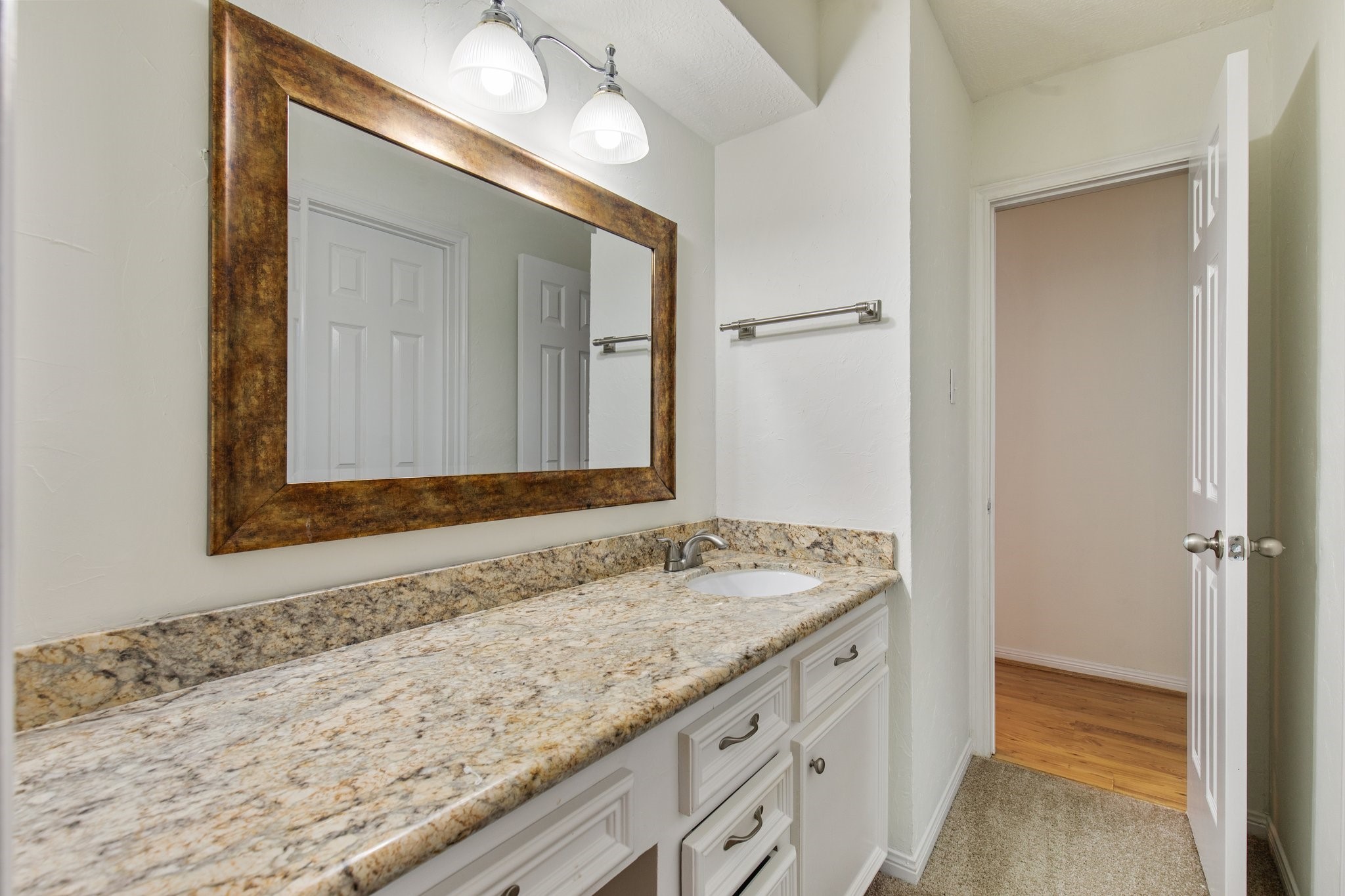 17902 Fernbluff Drive Spring, TX 77379 - Photo 26 of 38 a bathroom with a granite countertop sink and a mirror