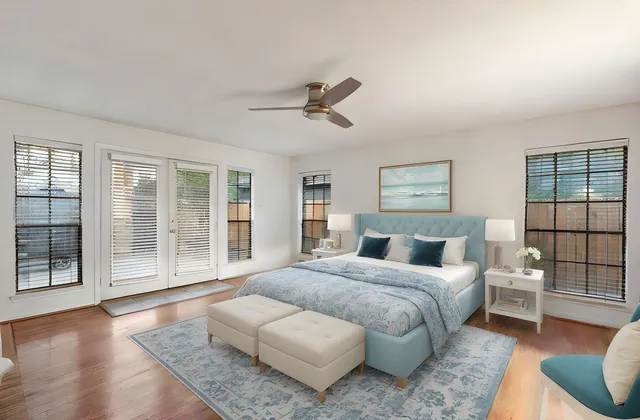 a bedroom with a large bed and glass window