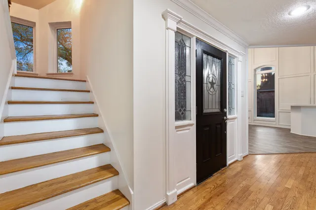 a view of entryway and hall with wooden floor