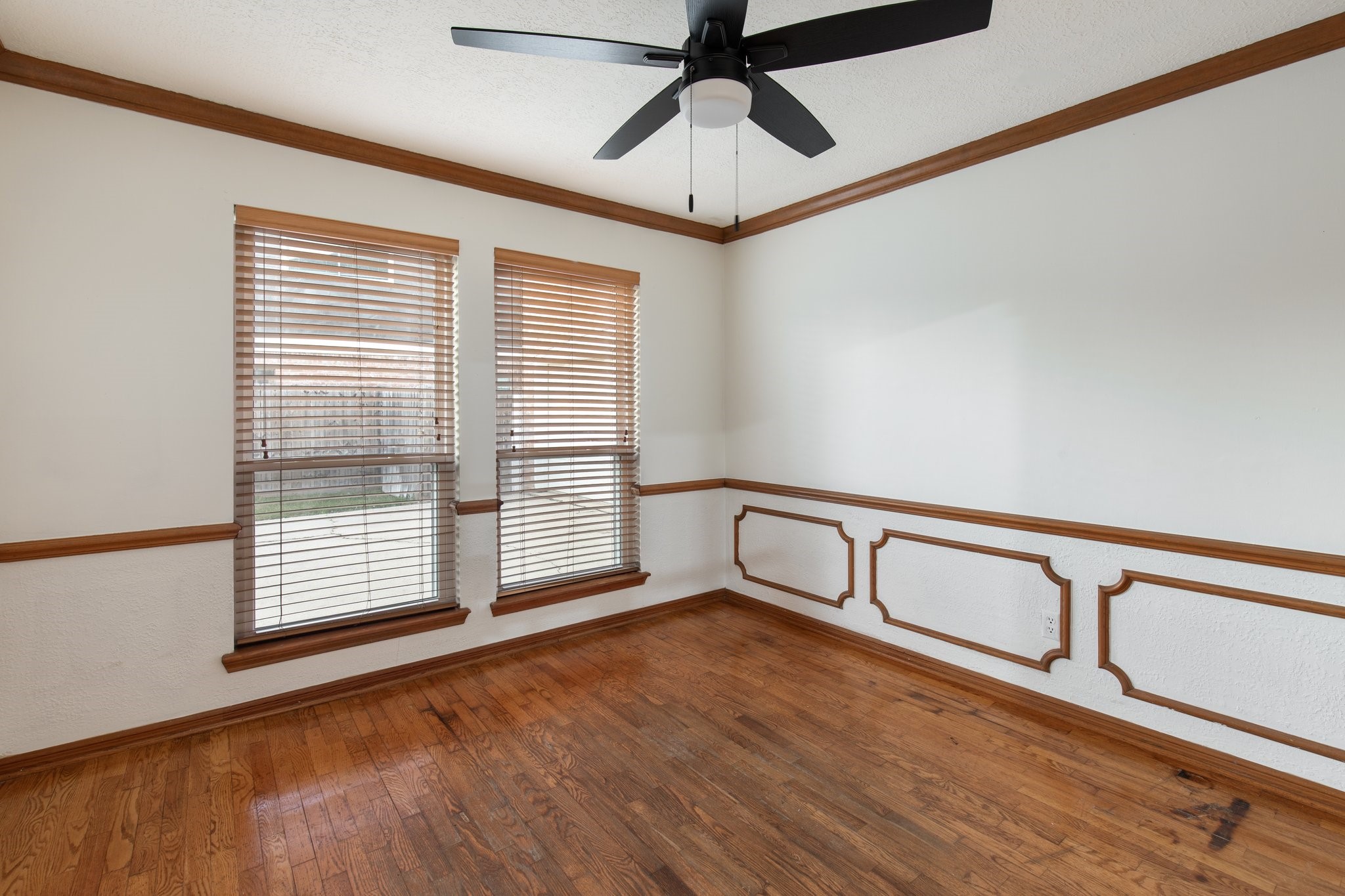 17902 Fernbluff Drive Spring, TX 77379 - Photo 9 of 38 a view of an empty room with chandelier fan and wooden floor