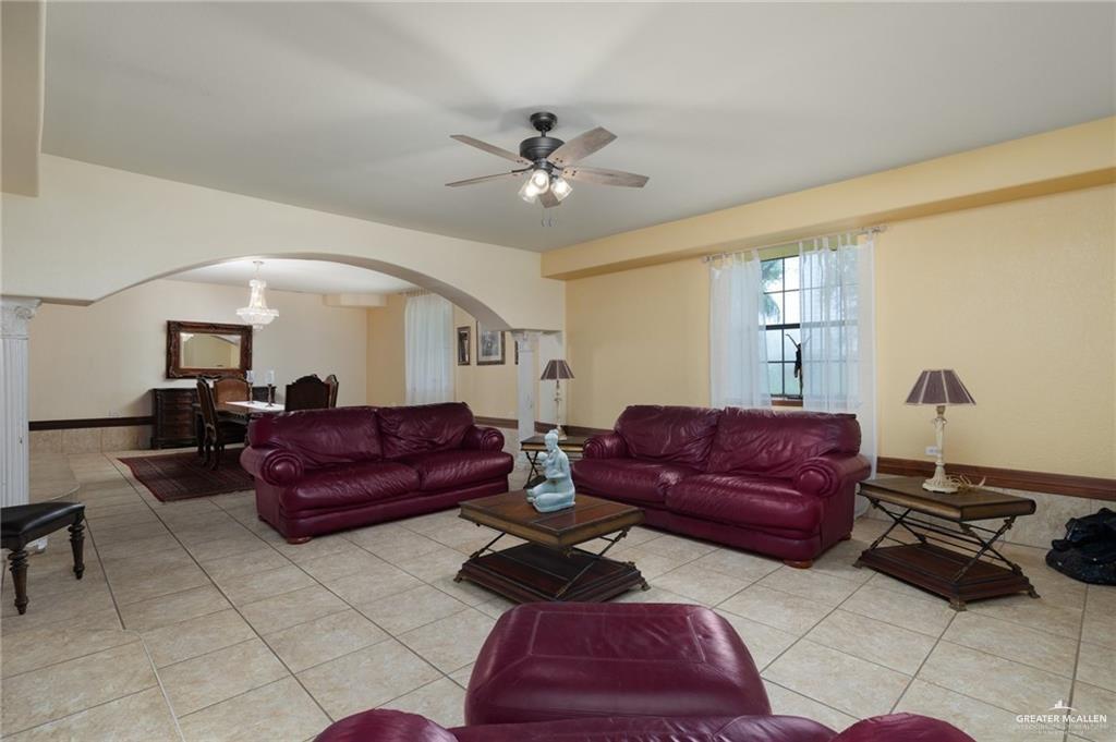 4523 South Tower Road Edinburg, TX 78542 - Photo 11 of 34 a living room with furniture and a chandelier
