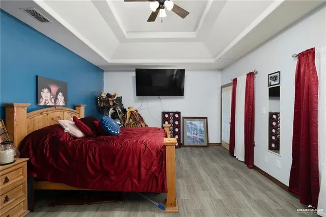 a bedroom that has a bed and a chandelier